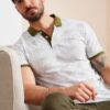 Lolida, فروش تیشرت مردانه پنبه ای یقه سه دکمه طرح‎دار سفید با کیفیت عالی و رنگ زیبا و طرح شیک و قیمت عمده ساخت برند Buratti .